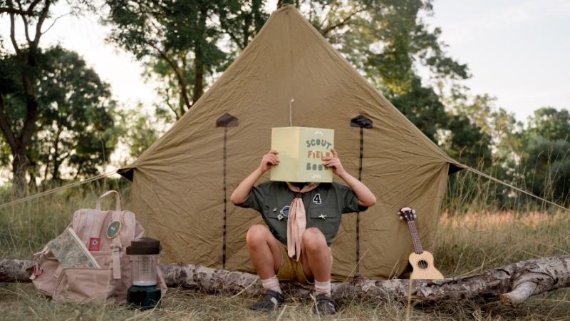 Scout camping gadgets laid out for a safe outdoor trip