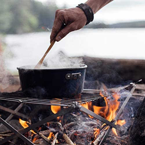 Compact folding camping BBQ grill set up for outdoor cooking