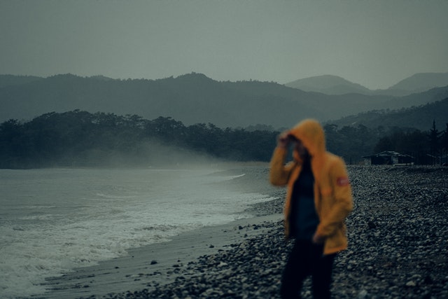 Hiker wearing a rain jacket on a wet trail