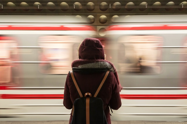 Disadvantages of travelling by train with passengers waiting at a railway station