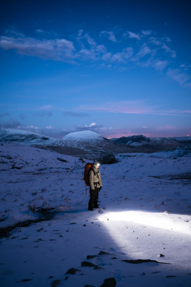 Camping and hiking headlamp lighting a dark outdoor scene