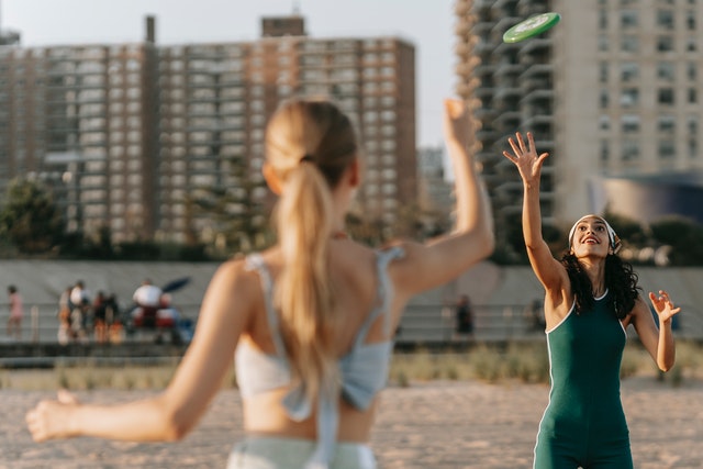 People playing with a frisbee on the beach