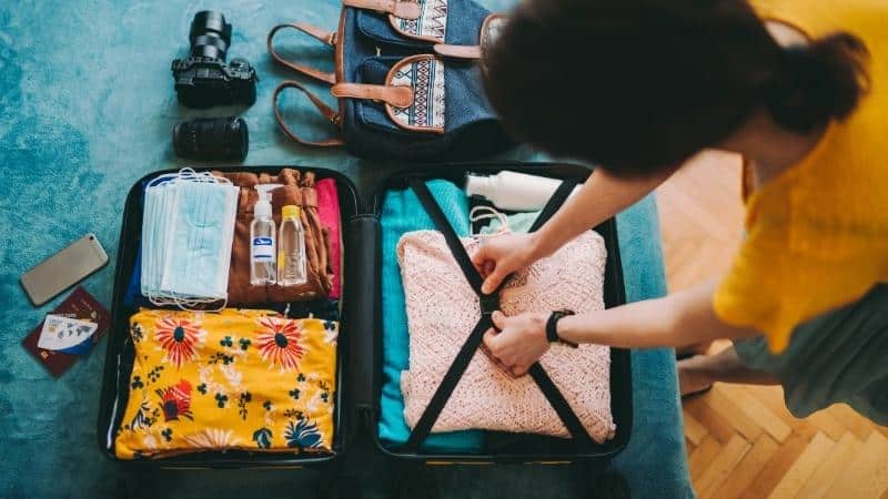 Travel essentials for women packed neatly for a trip