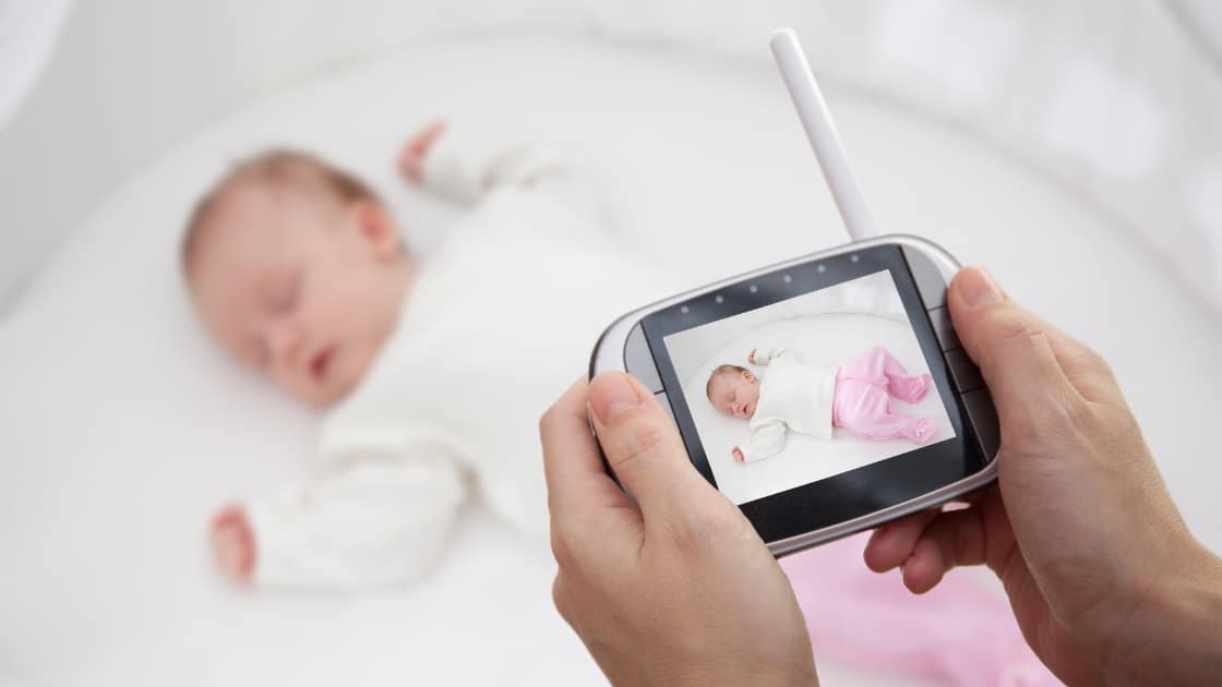 Portable travel baby monitor set up safely away from a baby sleep space
