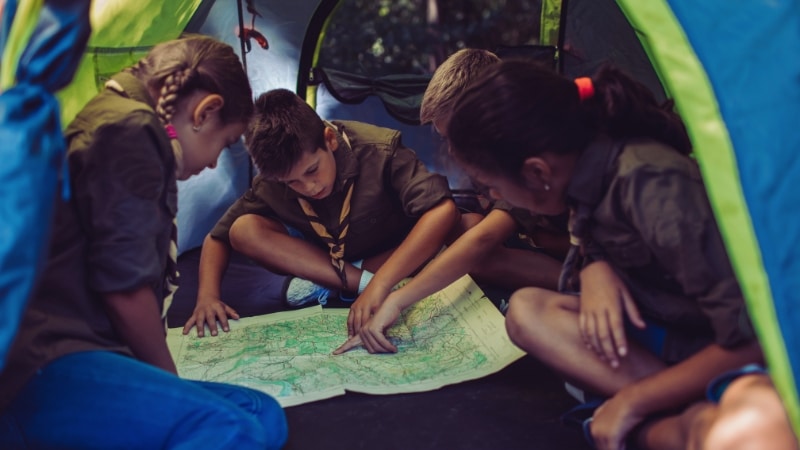 Scouts sitting inside a camping tent